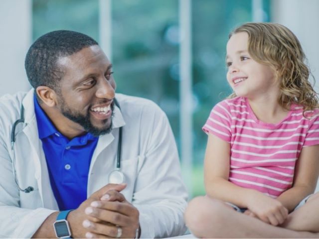 nurse practitioncer with pediatric patient