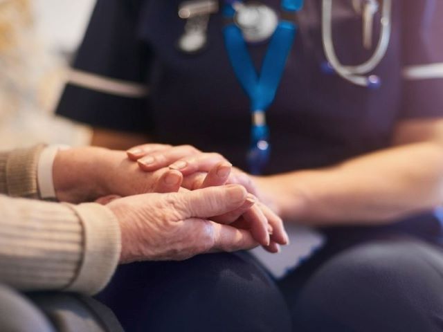 hospice nurse comforting patient