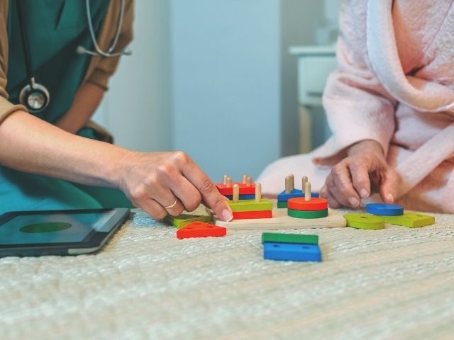 nurse helping patient with neurological issue