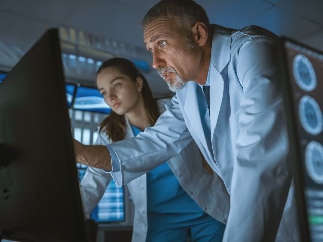 neurologist and nurse reviewing scans