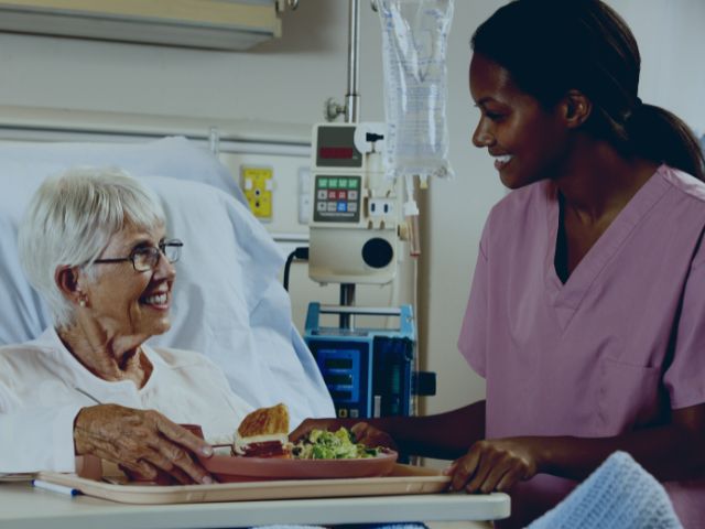 Nurse discussing  with a patient about their progress on antidiarrheal medication.